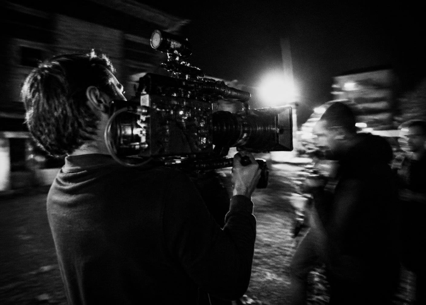 Camera operator filming at night