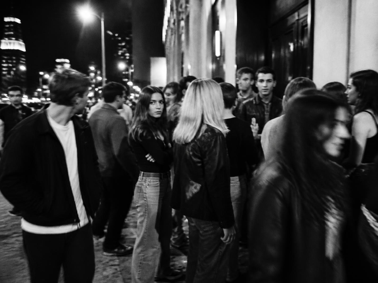 Crowd waiting outside a venue at night